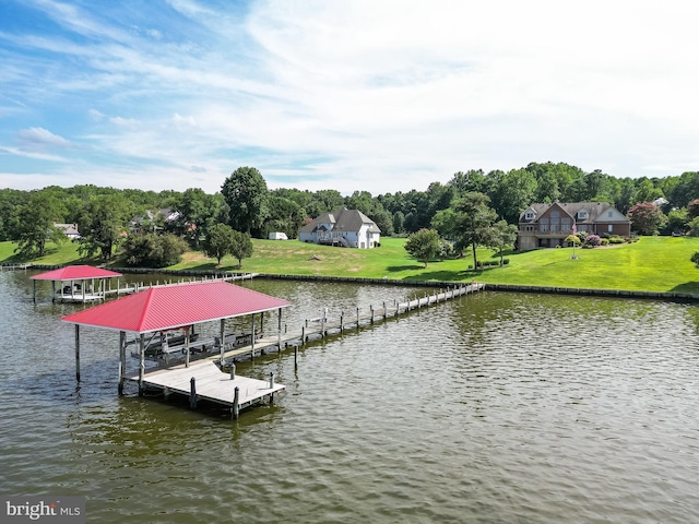 dock area with a lawn, a water view, and boat lift