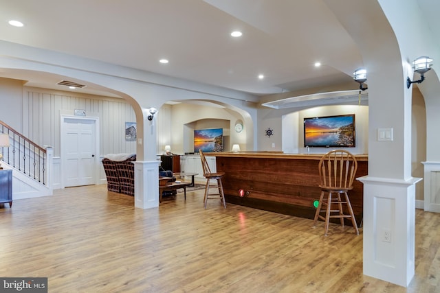 reception area featuring arched walkways, visible vents, and stairway