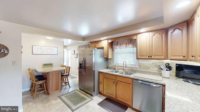 1550 Beacon St, Keyser, WV 26726 - kitchen featuring baseboards, a kitchen breakfast bar, a sink, appliances with stainless steel finishes, and backsplash