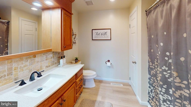 1550 Beacon St, Keyser, WV 26726 - full bath featuring vanity, baseboards, decorative backsplash, wood finished floors, and visible vents