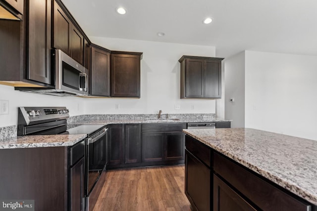 3798 Castle Dr Lot 292, Dover, PA 17315 - kitchen featuring appliances with stainless steel finishes, light stone countertops, wood finished floors, recessed lighting, and dark brown cabinets