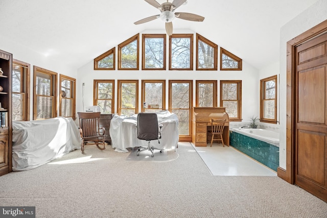 interior space with a ceiling fan, carpet floors, and high vaulted ceiling