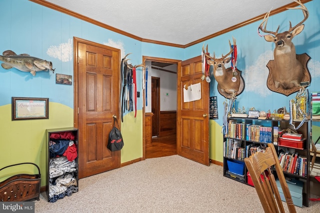 bedroom featuring wooden walls, carpet, a textured ceiling, and crown molding