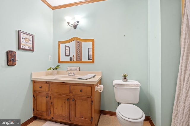 bathroom with baseboards, toilet, and vanity