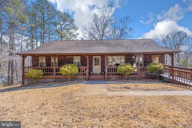 view of front of property with a porch and roof with shingles