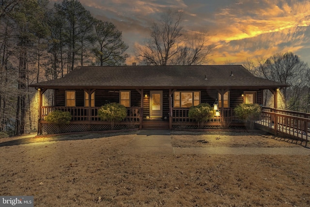 view of front of home featuring roof with shingles and covered porch