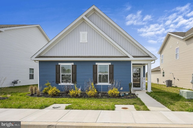 10883 Farmerfield St, Milford, DE 19963 - view of front of property featuring central AC unit, board and batten siding, and a front yard