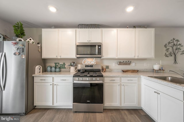 10883 Farmerfield St, Milford, DE 19963 - kitchen featuring wood finished floors, a sink, stainless steel appliances, white cabinets, and recessed lighting