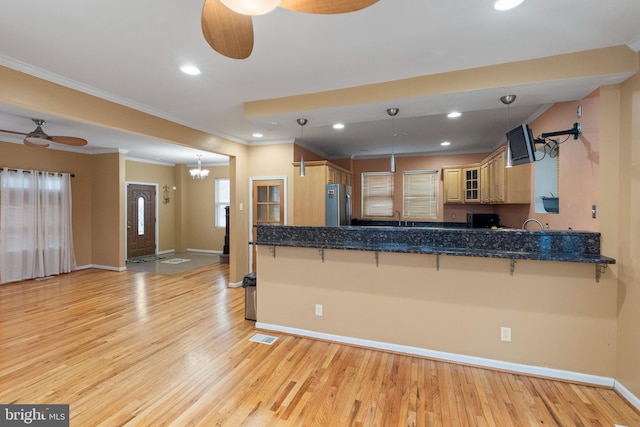 4626 Kavon Ave, Baltimore, MD 21206 - kitchen with freestanding refrigerator, baseboards, a breakfast bar area, and ceiling fan with notable chandelier