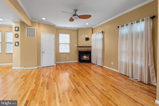 4626 Kavon Ave, Baltimore, MD 21206 - unfurnished living room featuring a ceiling fan, visible vents, crown molding, a fireplace with flush hearth, and light wood-type flooring