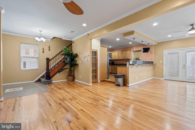 4626 Kavon Ave, Baltimore, MD 21206 - unfurnished living room with baseboards, light wood-style floors, crown molding, and ceiling fan with notable chandelier