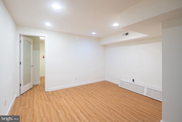finished below grade area featuring recessed lighting, wood finished floors, visible vents, and baseboards