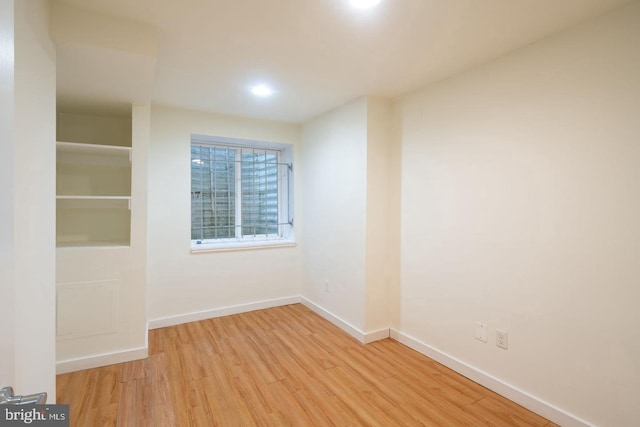 unfurnished room featuring wood finished floors and baseboards