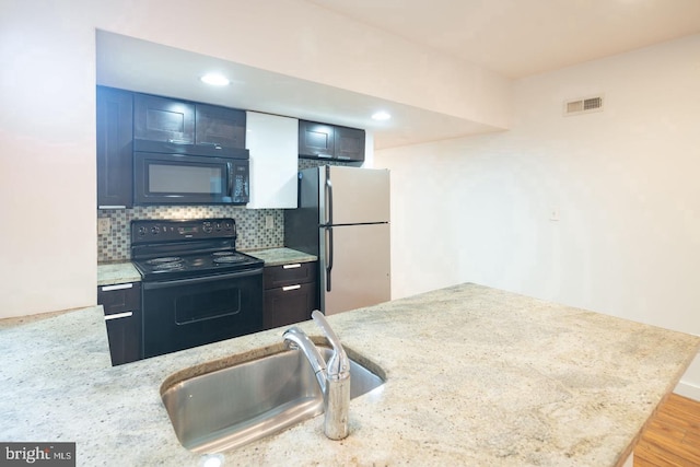kitchen featuring a sink, visible vents, recessed lighting, backsplash, and black appliances