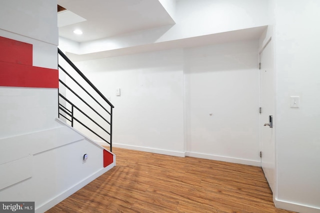 stairs with baseboards and wood finished floors