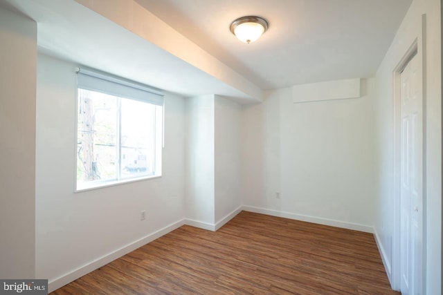 empty room with wood finished floors and baseboards