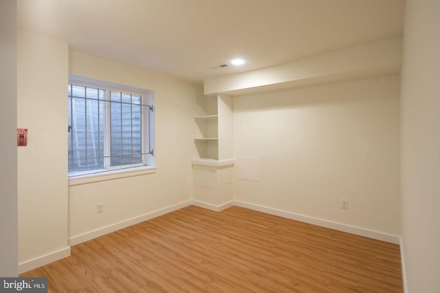 spare room featuring light wood-style flooring, baseboards, and recessed lighting