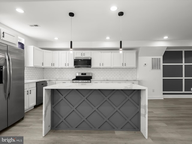 3833 Reisterstown Rd, Baltimore, MD 21215 - kitchen with decorative backsplash, stainless steel appliances, white cabinetry, and visible vents