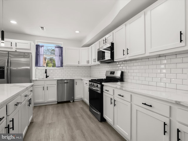 3833 Reisterstown Rd, Baltimore, MD 21215 - kitchen with white cabinets, stainless steel appliances, visible vents, and a sink