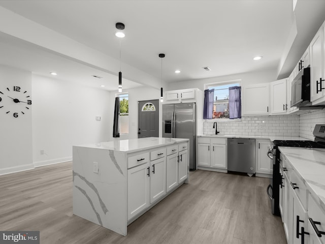 3833 Reisterstown Rd, Baltimore, MD 21215 - kitchen featuring light wood-style flooring, tasteful backsplash, a healthy amount of sunlight, and stainless steel appliances