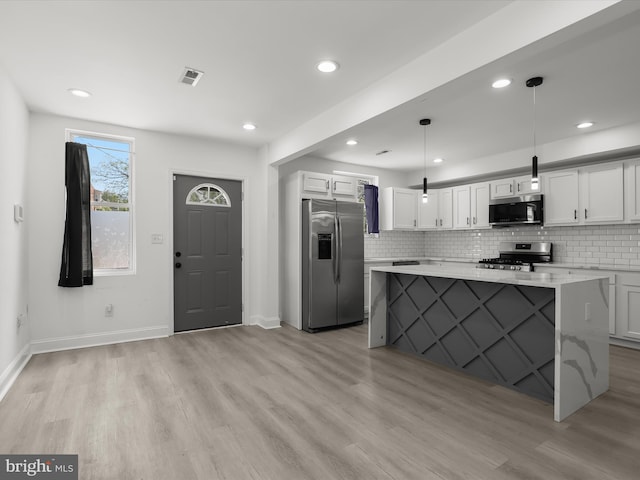 3833 Reisterstown Rd, Baltimore, MD 21215 - kitchen featuring light countertops, baseboards, white cabinets, light wood-style floors, and stainless steel appliances