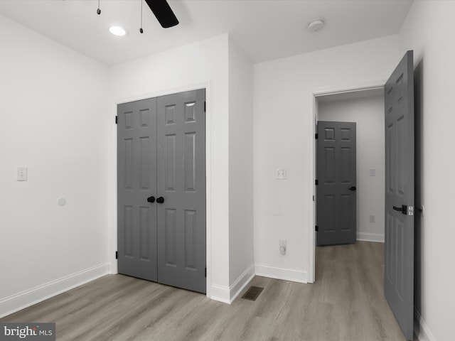 3833 Reisterstown Rd, Baltimore, MD 21215 - unfurnished bedroom with light wood-style flooring, a ceiling fan, baseboards, visible vents, and a closet