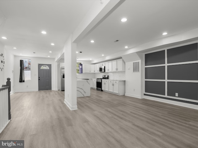 3833 Reisterstown Rd, Baltimore, MD 21215 - unfurnished living room featuring recessed lighting, light wood finished floors, and a healthy amount of sunlight