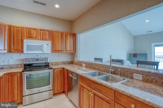 11 Marina View Ct Unit A-6, Bethany Beach, DE 19930 - kitchen featuring a sink, stainless steel appliances, brown cabinets, and visible vents
