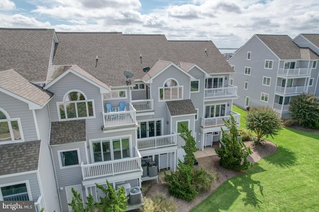 11 Marina View Ct Unit A-6, Bethany Beach, DE 19930 - back of property featuring a lawn, roof with shingles, and a balcony