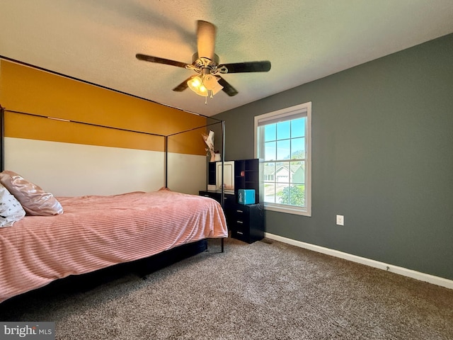 carpeted bedroom with a ceiling fan and baseboards