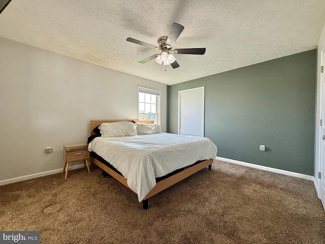 carpeted bedroom featuring baseboards, a ceiling fan, and a textured ceiling