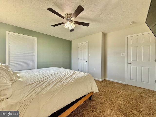 carpeted bedroom featuring a textured ceiling, ceiling fan, and baseboards
