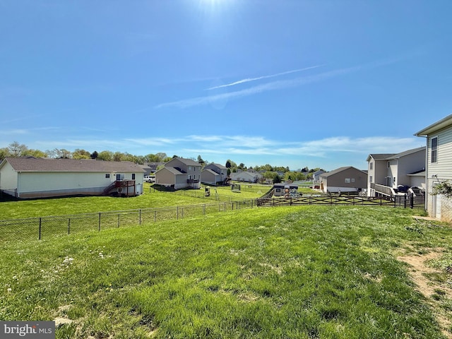 view of yard with a fenced backyard and a residential view