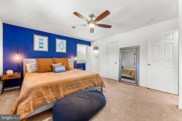 carpeted bedroom with baseboards and a ceiling fan