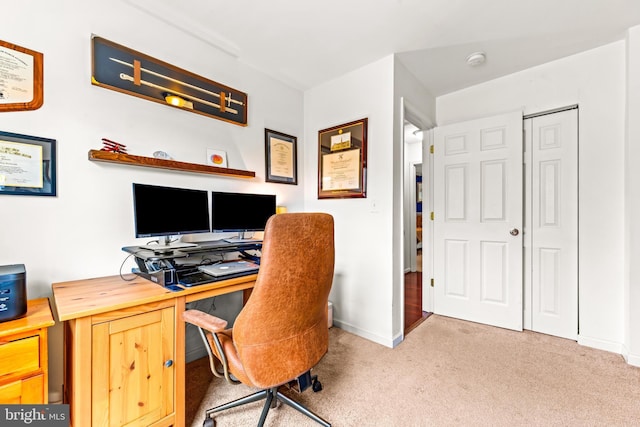 carpeted office space with baseboards