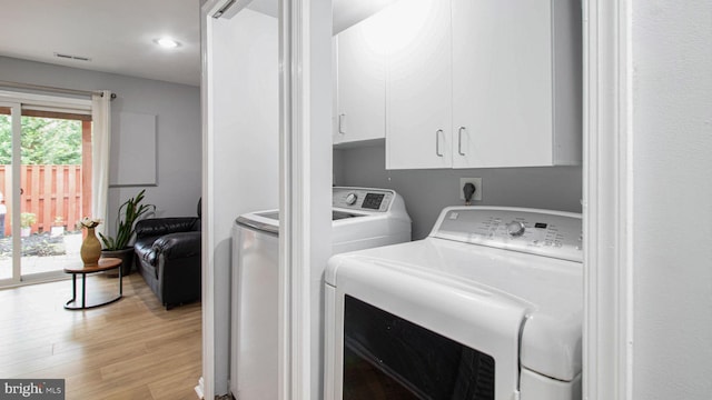 46932 Trumpet Cir, Sterling, VA 20164 - laundry room featuring cabinet space, washer and dryer, light wood-style flooring, and recessed lighting
