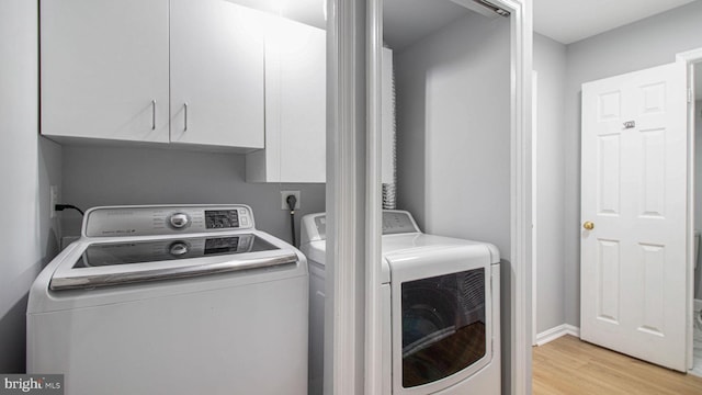 46932 Trumpet Cir, Sterling, VA 20164 - washroom with cabinet space, washer and dryer, and light wood finished floors