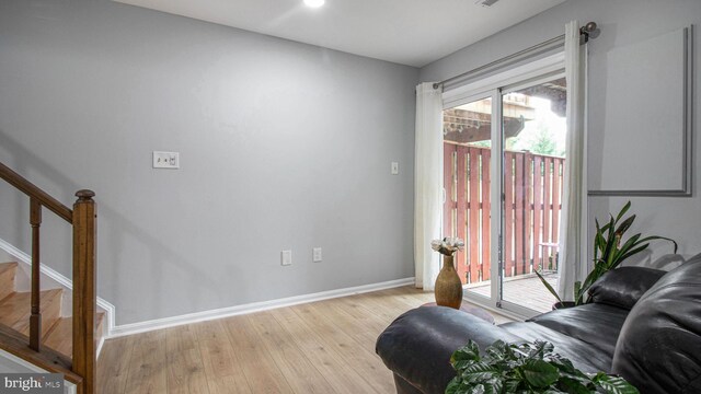 46932 Trumpet Cir, Sterling, VA 20164 - living area featuring baseboards, stairway, and light wood-style flooring