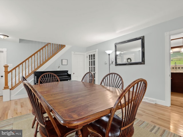 12943 Harford Rd, Hydes, MD 21082 - dining room with stairway, light wood-type flooring, and baseboards