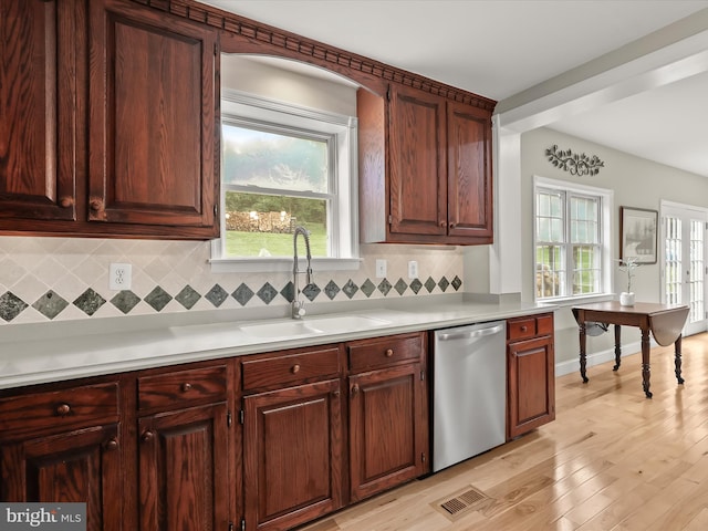 12943 Harford Rd, Hydes, MD 21082 - kitchen with dishwasher, a sink, backsplash, light countertops, and light wood-style floors