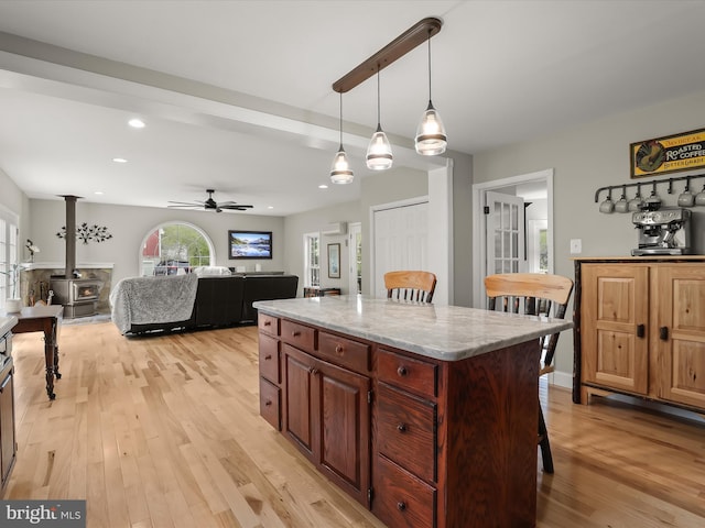 12943 Harford Rd, Hydes, MD 21082 - kitchen featuring light wood-style flooring, hanging light fixtures, a center island, a breakfast bar, and recessed lighting
