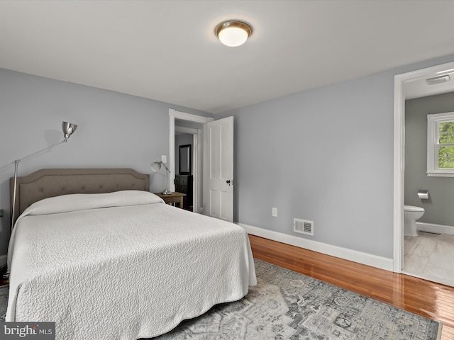 12943 Harford Rd, Hydes, MD 21082 - bedroom featuring wood finished floors, baseboards, and ensuite bath