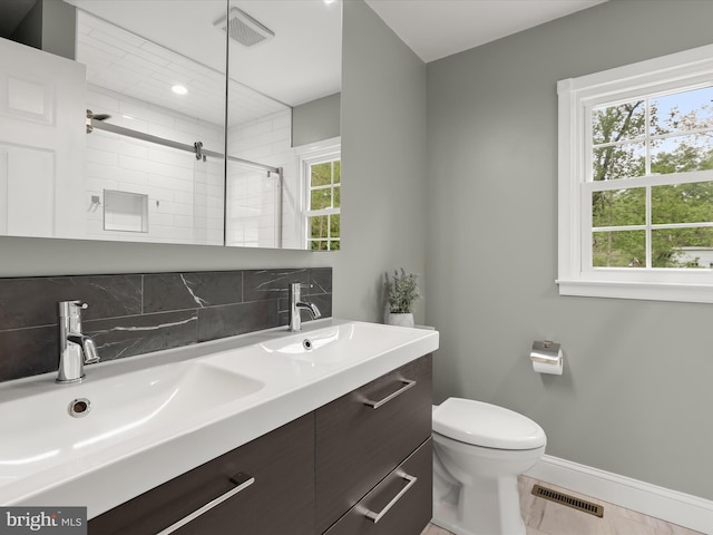 12943 Harford Rd, Hydes, MD 21082 - bathroom featuring baseboards, tiled shower, tasteful backsplash, toilet, and double vanity