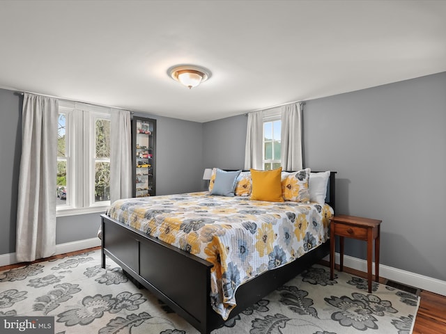 12943 Harford Rd, Hydes, MD 21082 - bedroom with baseboards, multiple windows, and wood finished floors