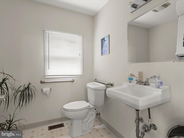 12943 Harford Rd, Hydes, MD 21082 - bathroom featuring baseboards, toilet, tile patterned floors, and a sink