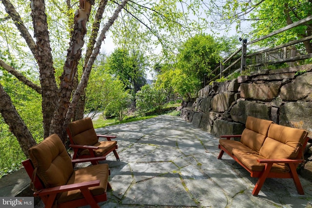 view of patio / terrace with an outdoor living space and fence