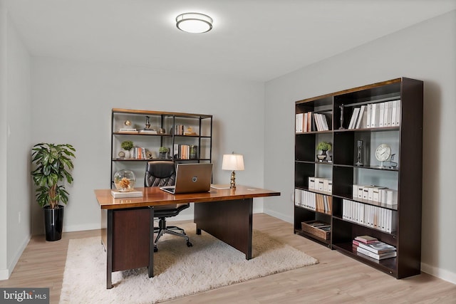 office space featuring baseboards and wood finished floors