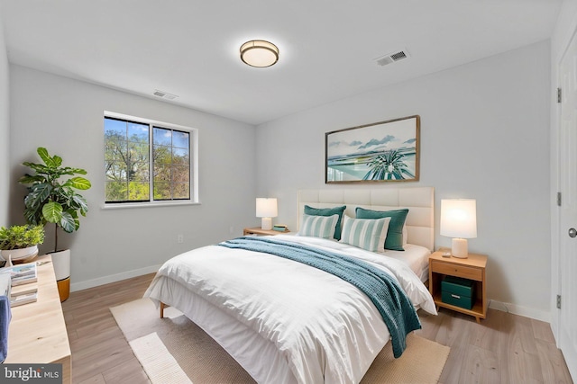 bedroom with visible vents, baseboards, and light wood-type flooring