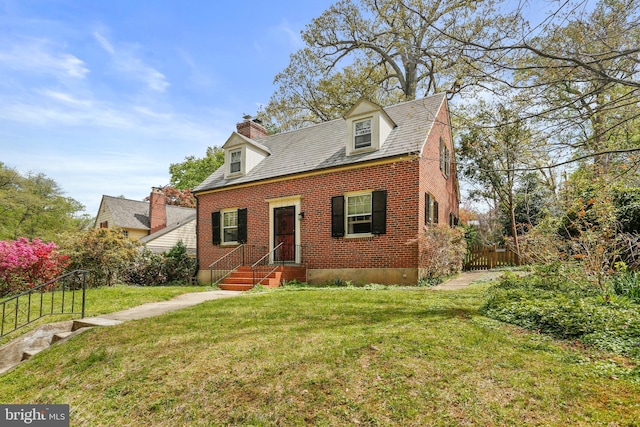 cape cod-style house featuring brick siding, a front lawn, fence, and a chimney