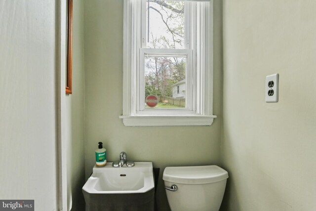 half bath with a sink and toilet